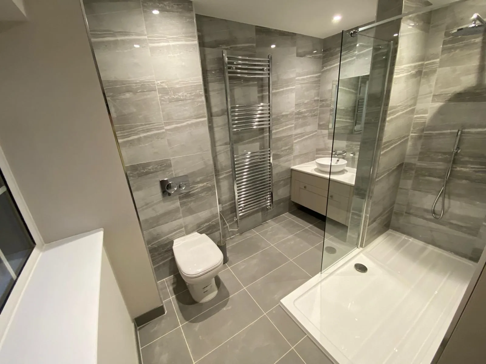 Modern grey-tiled bathroom fitted by Pangbourne Plumbing