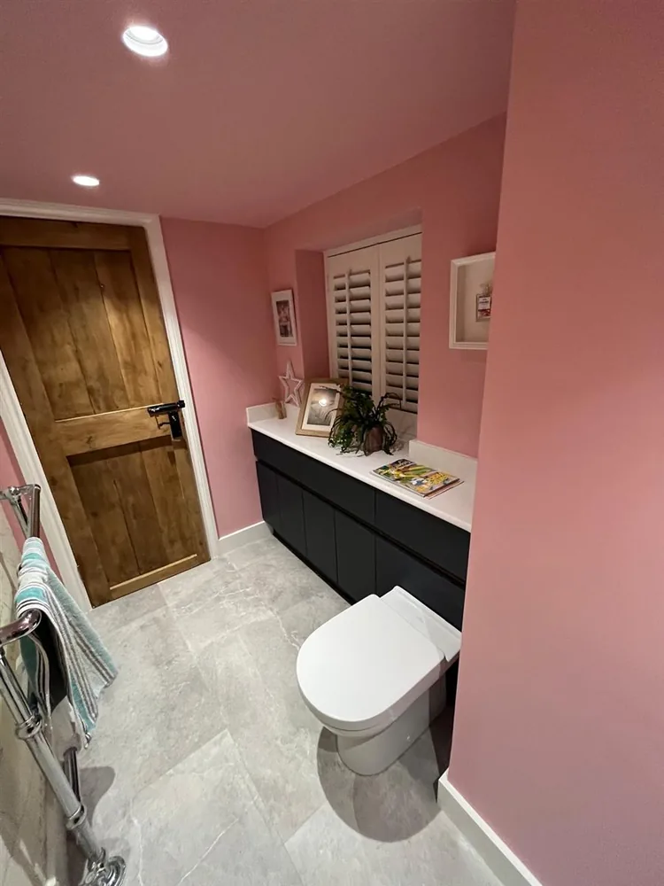 Pink cloakroom with navy vanity