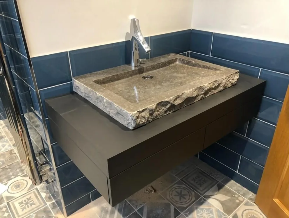 Carved stone basin and floating vanity fitted by Pangbourne Plumbing